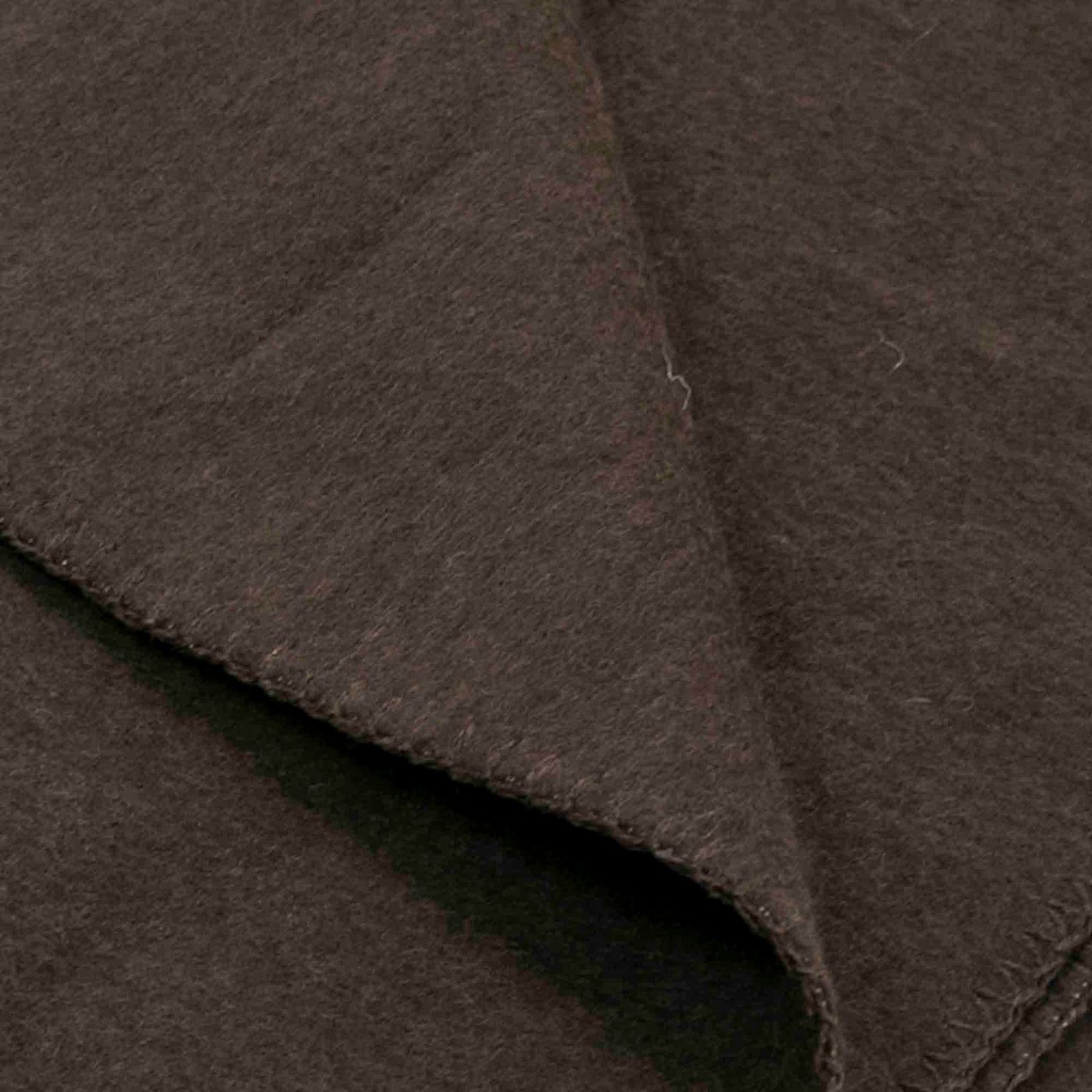 “Dark brown blanket made of 100% Mongolian yak wool, folded neatly, handcrafted for warmth and natural comfort.”