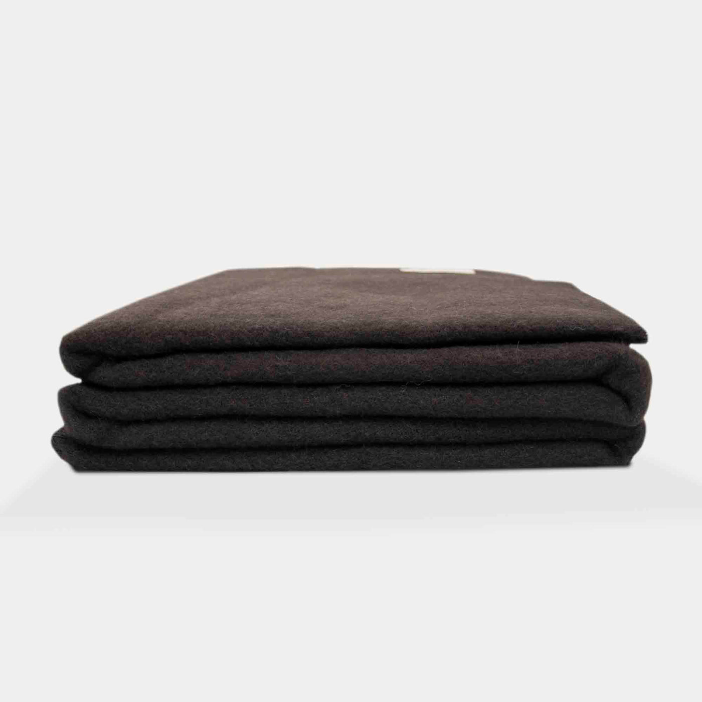 “Dark brown blanket made of 100% Mongolian yak wool, folded neatly, handcrafted for warmth and natural comfort.”