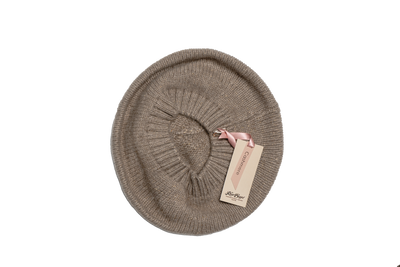 Beige Mongolian cashmere beret with delicate metallic shimmer and soft knit texture, offering timeless warmth and refined winter style.