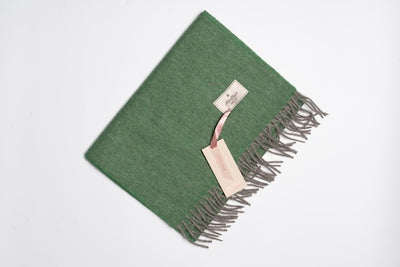Green and grey 100% yak wool scarf with soft woven texture and fringe edges, showcasing natural warmth and minimalist sustainable design.