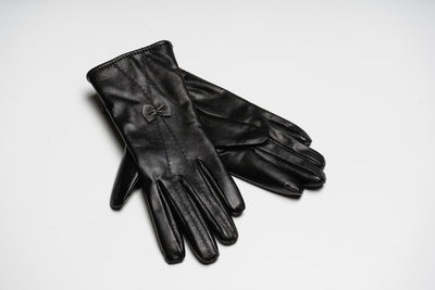 “Black women’s leather gloves with fine stitching and bow detail, elegant soft natural leather design for warmth and style”
