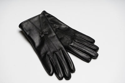 “Black women’s leather gloves with fine stitching and bow detail, elegant soft natural leather design for warmth and style”