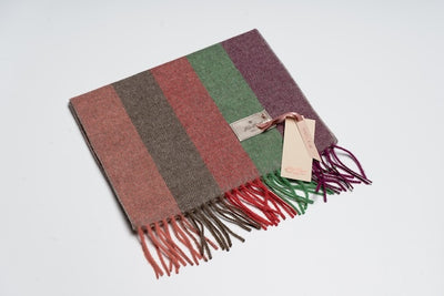 Striped yak wool scarf featuring earthy brown, red, green, and plum tones with fringe edges, crafted from 100% Mongolian yak wool for warmth and sustainable style.