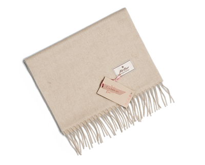 Light beige Mongolian cashmere scarf with fringe edges and soft texture, offering lightweight warmth and minimalist luxury design.