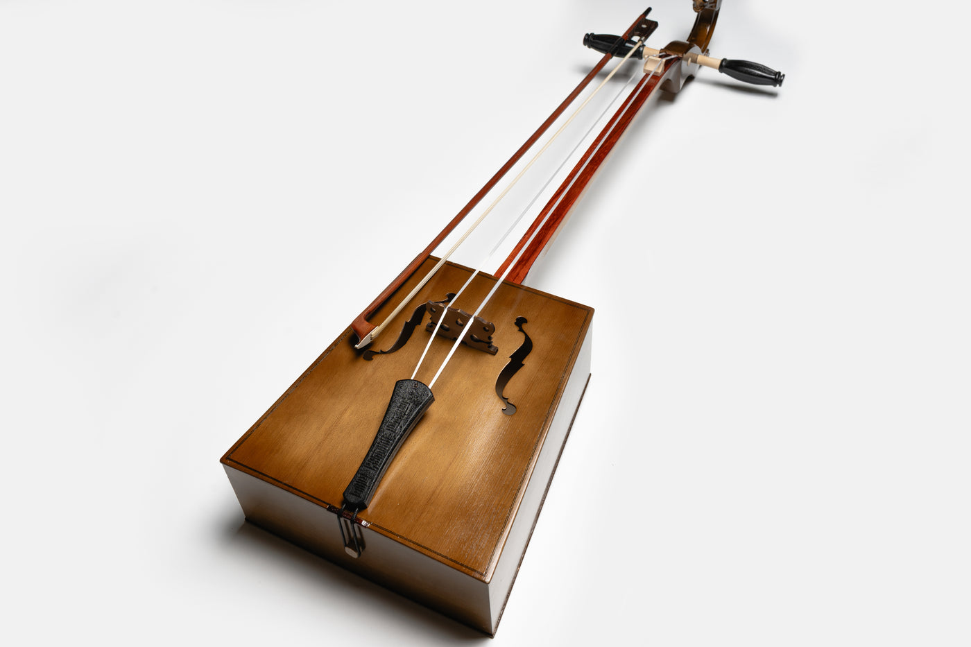 “Handcrafted Mongolian Morin Khuur horsehead fiddle with wooden body and bow, traditional string instrument symbolizing Mongolian culture.”