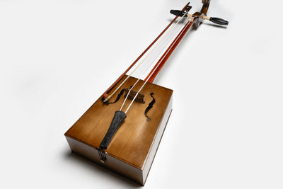 “Handcrafted Mongolian Morin Khuur horsehead fiddle with wooden body and bow, traditional string instrument symbolizing Mongolian culture.”