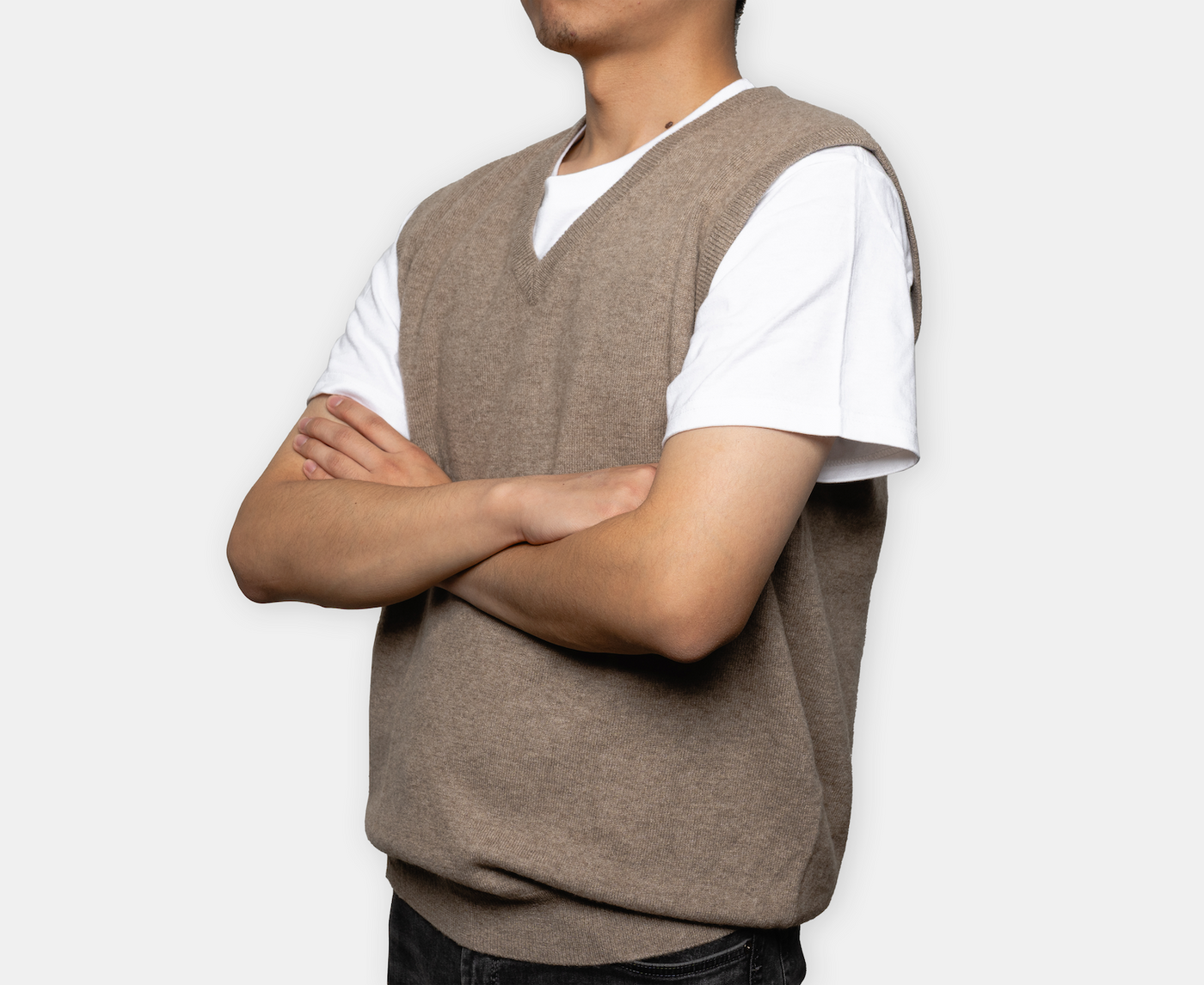 Natural brown V-neck cashmere vest with soft knit texture, crafted from pure Mongolian cashmere for a refined and versatile winter look.