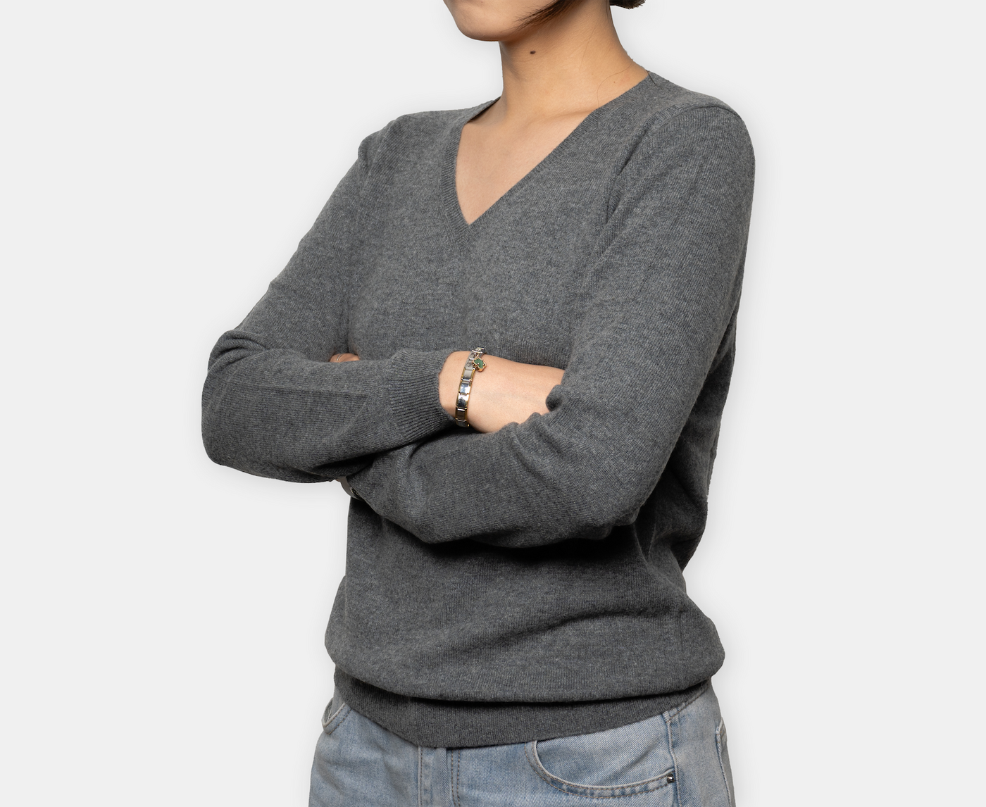 Women’s dark gray V-neck cashmere sweater with soft knit texture and classic fit, offering lightweight warmth and timeless minimalist elegance.