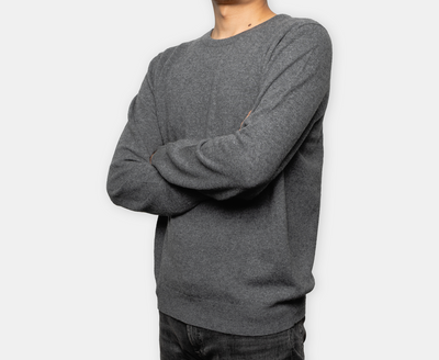 Men’s dark grey crew neck cashmere jumper with soft knit texture, offering lightweight warmth and minimalist elegance.