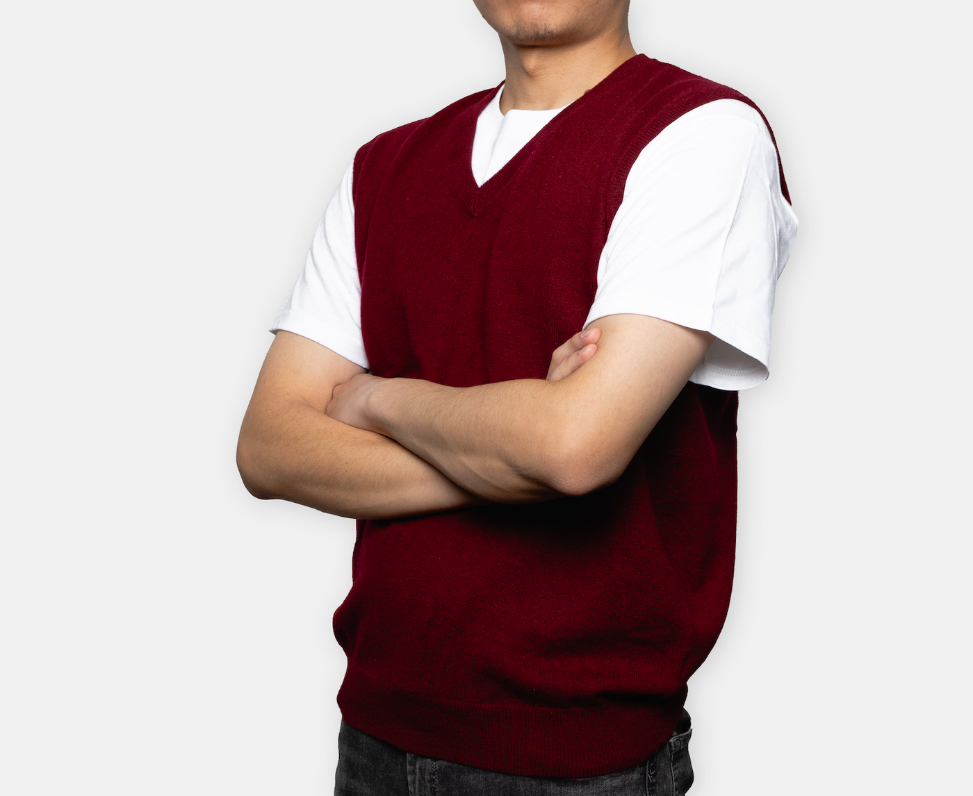 Burgundy V-neck cashmere vest with soft knit texture, crafted from pure Mongolian cashmere for a refined and versatile winter look.