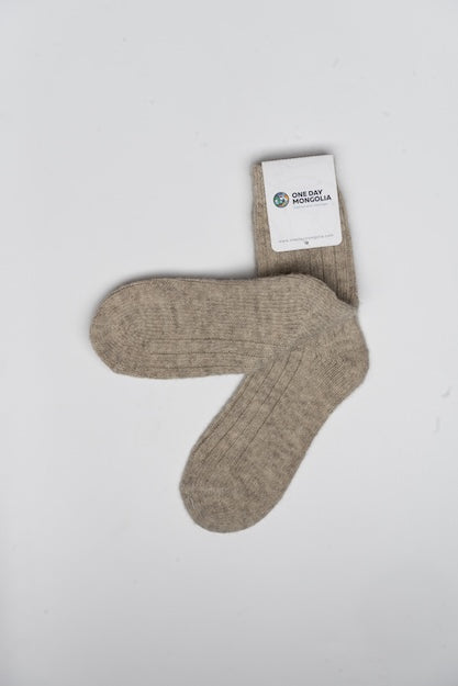 “Beige 100% Mongolian wool socks with ribbed knit texture, soft natural fibers for warmth and comfort”