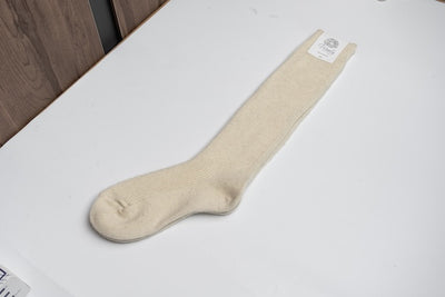 “Cream-colored 100% Mongolian sheep wool long socks with ribbed knit texture, natural warmth and breathable comfort”