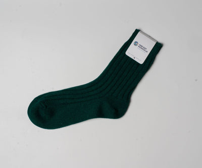 “Green wool blend Christmas sock made with 60% Mongolian sheep wool, ribbed texture, eco-friendly winter wear.”