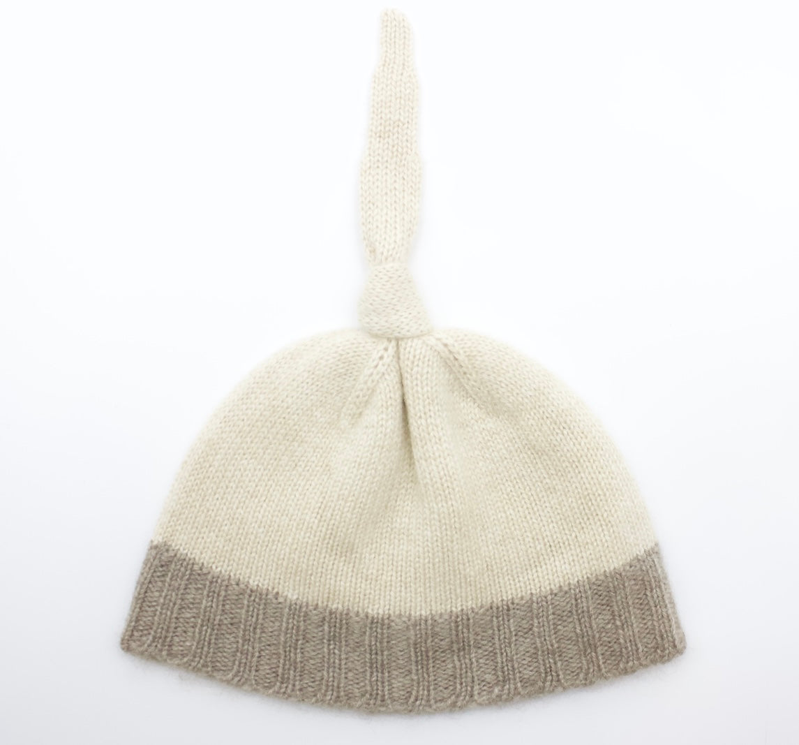 “Two-tone Mongolian cashmere baby hat with top knot, soft knit design in beige and brown tones, warm and hypoallergenic”