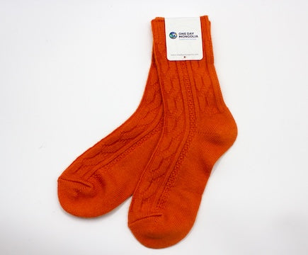 “Orange Mongolian wool blend socks with ribbed knit pattern, 60% wool for natural warmth and breathable comfort”