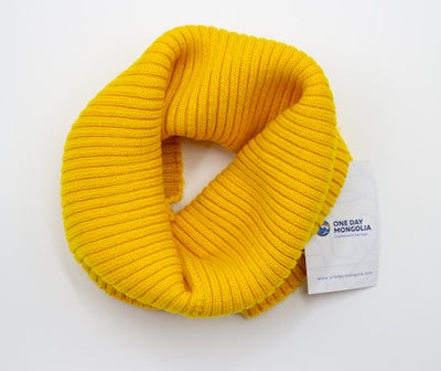 “Yellow Mongolian wool blend neck warmer with ribbed knit texture, 60% wool for breathable natural warmth”