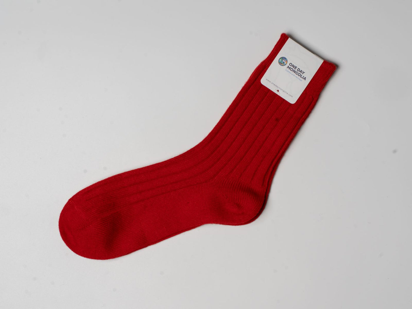 “Red wool blend Christmas sock made with 60% Mongolian sheep wool, ribbed texture, eco-friendly winter wear.”