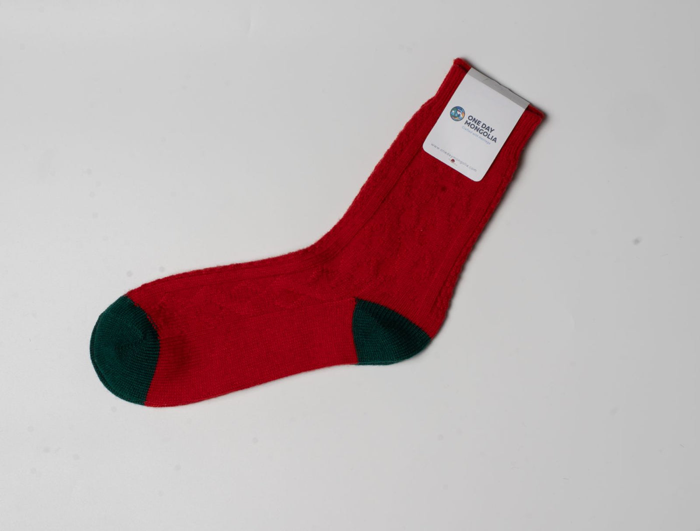 “Red and green wool blend Christmas sock made with 60% Mongolian sheep wool, ribbed texture, eco-friendly winter wear.”