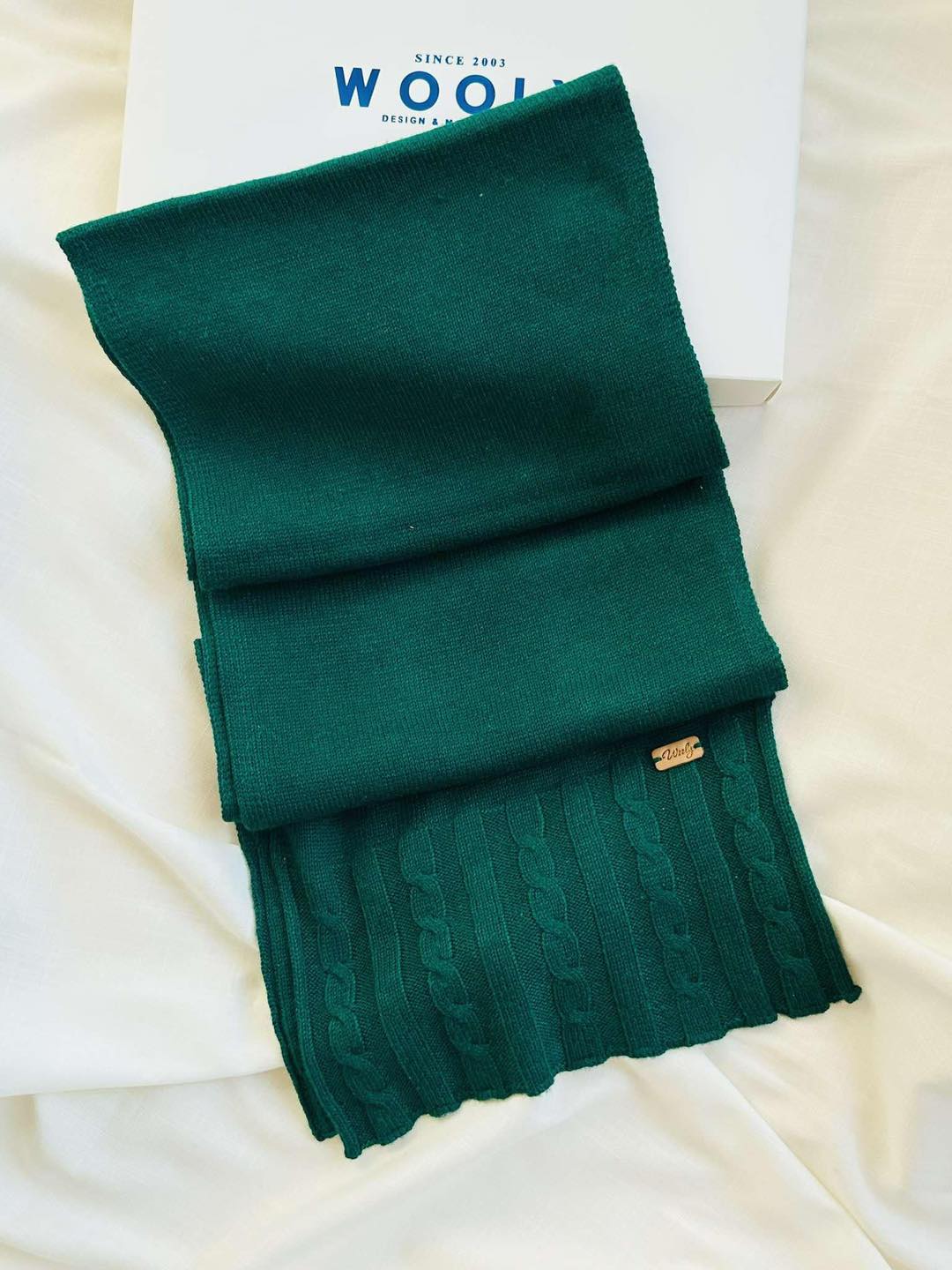 “Deep green Mongolian wool blend scarf with ribbed knit and cable pattern, 60% sheep wool for soft, breathable warmth”